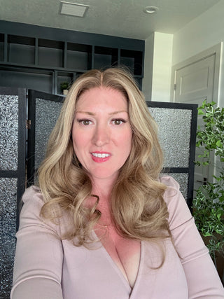 Beige champagne blonde human hair wig with realistic density and soft face-framing layers indoors natural light
