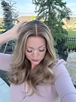 Natural parting on The Genevieve beige champagne blonde Remy human hair wig outdoors