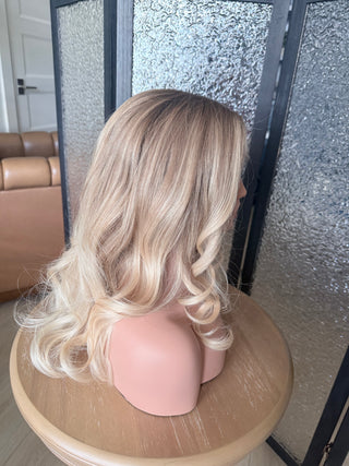 The Camille dimensional champagne blonde wig with soft natural movement indoors