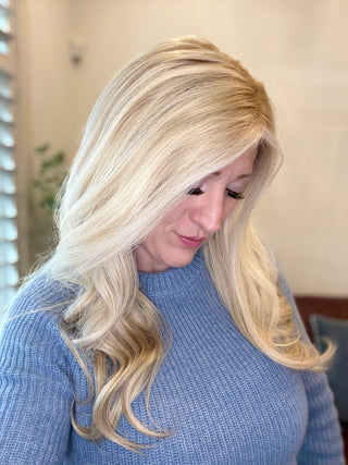 Woman with long silk top blonde hair wig wearing 